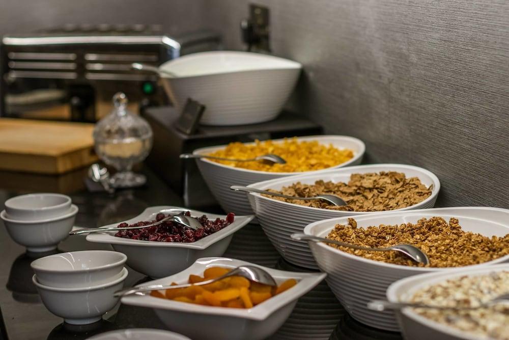 Hotel Montcalm Brewery Townhouse London Exterior foto The photo shows a variety of food items arranged on a countertop. There are several bowls containing different types of cereals and toppings. 

- One bowl features a light-colored granola.
- Another bowl holds what looks like corn flakes or a similar
